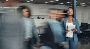 Two women walking through an office