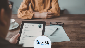 Hiring manager reviewing a resume on a tablet during a leasing consultant interview