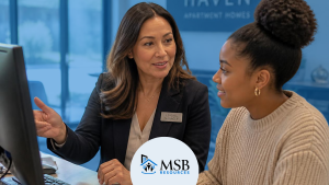 Property management mentor training a new leasing employee at the office